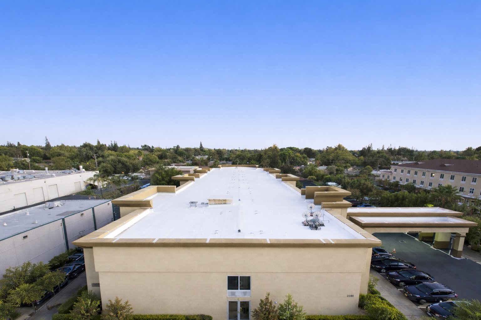 A commercial building protected by a finished white membrane roof