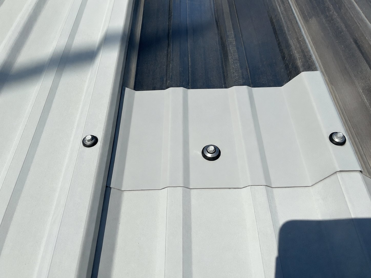 Bonded sealing screws securing a repair on a metal roof