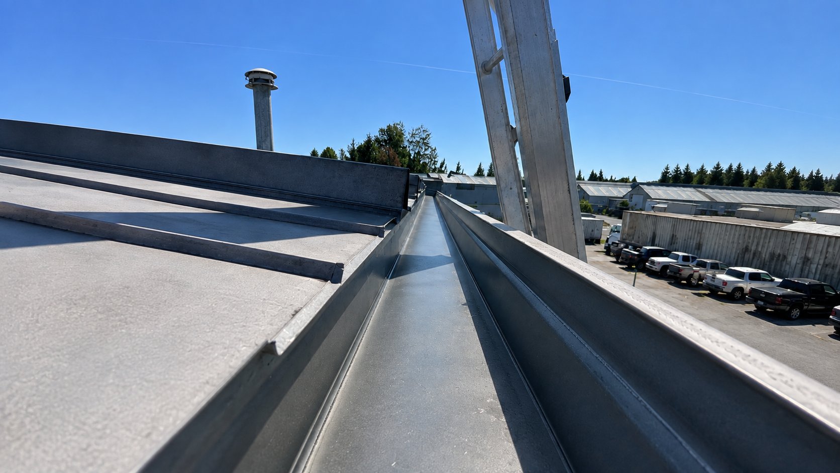 A clean commercial roof gutter ready to carry water away
