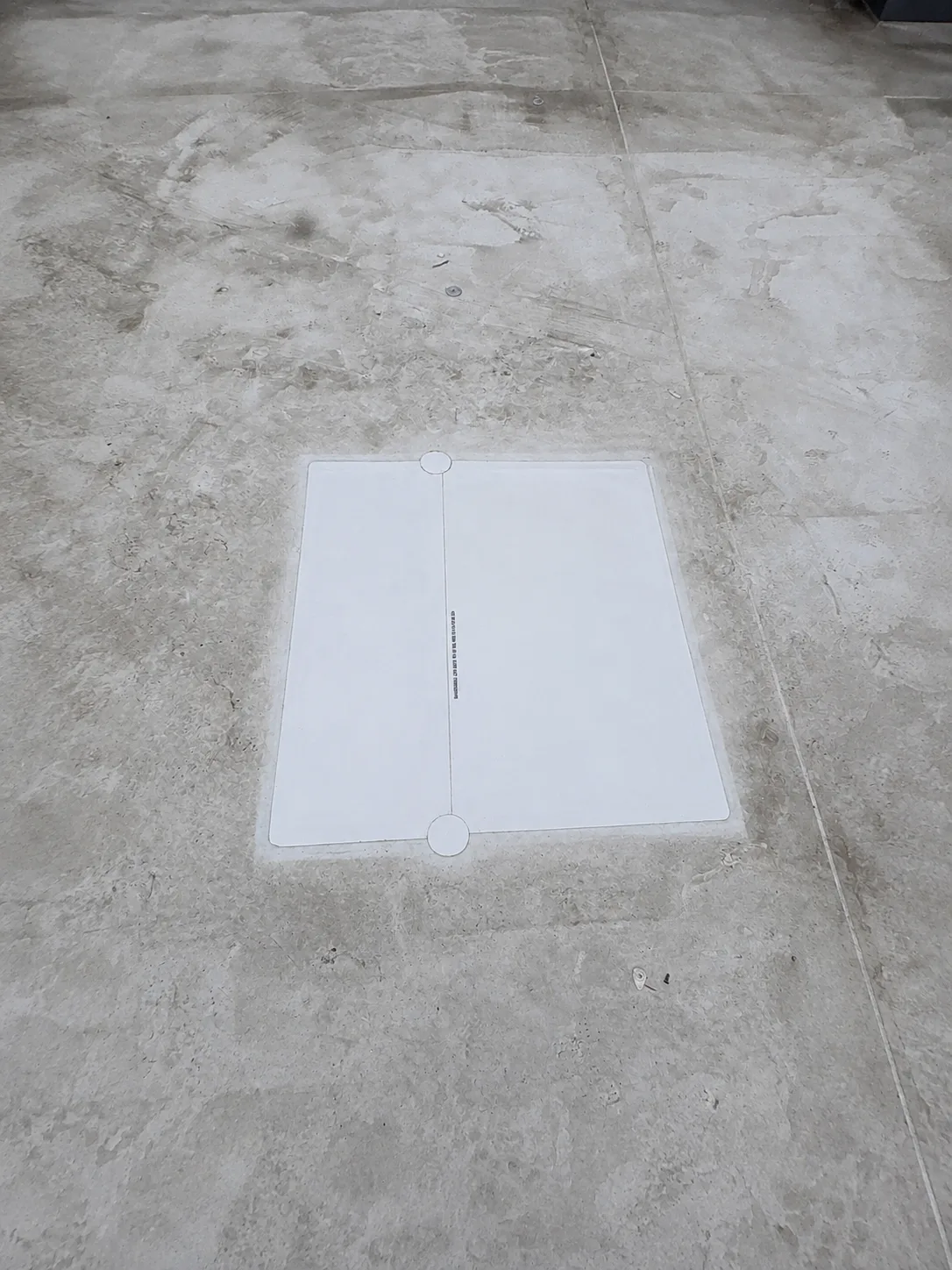 White rectangular membrane repair spanning a seam on a weathered light-colored roof