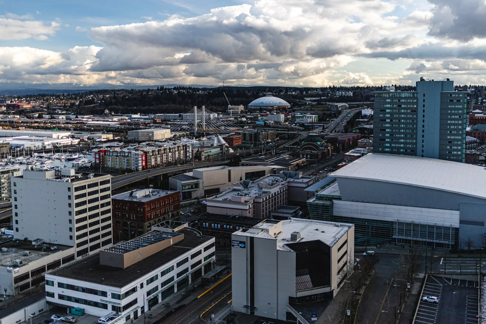 Downtown Tacoma rooftops with the convention center in the foreground and the Tacoma Dome in the distance