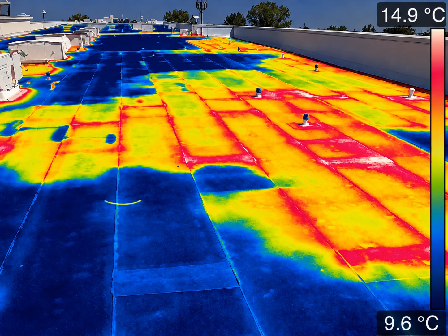 A roof image with a blue, yellow, and red thermal-style overlay and a temperature scale